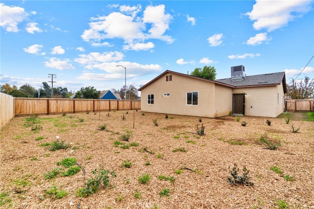 back of property featuring central air condition unit