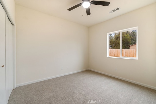 unfurnished room featuring carpet and ceiling fan