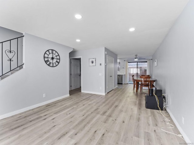 unfurnished living room with ceiling fan and light hardwood / wood-style floors