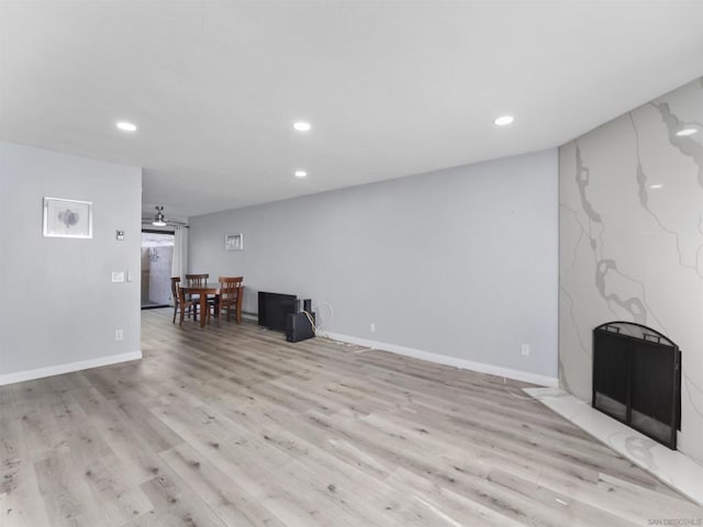 unfurnished living room featuring light wood-type flooring and a fireplace