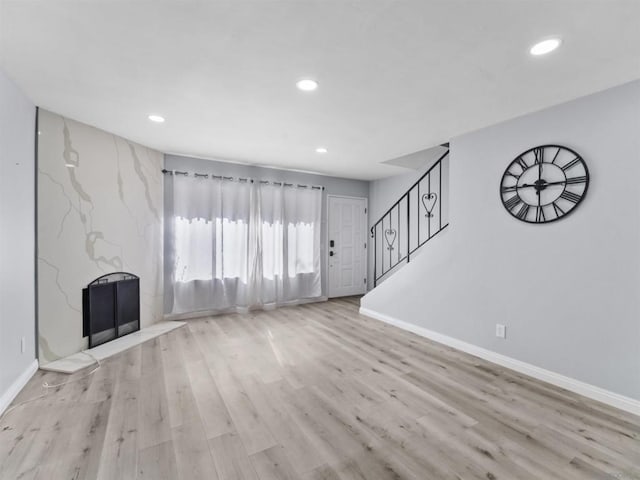 unfurnished living room featuring light hardwood / wood-style floors