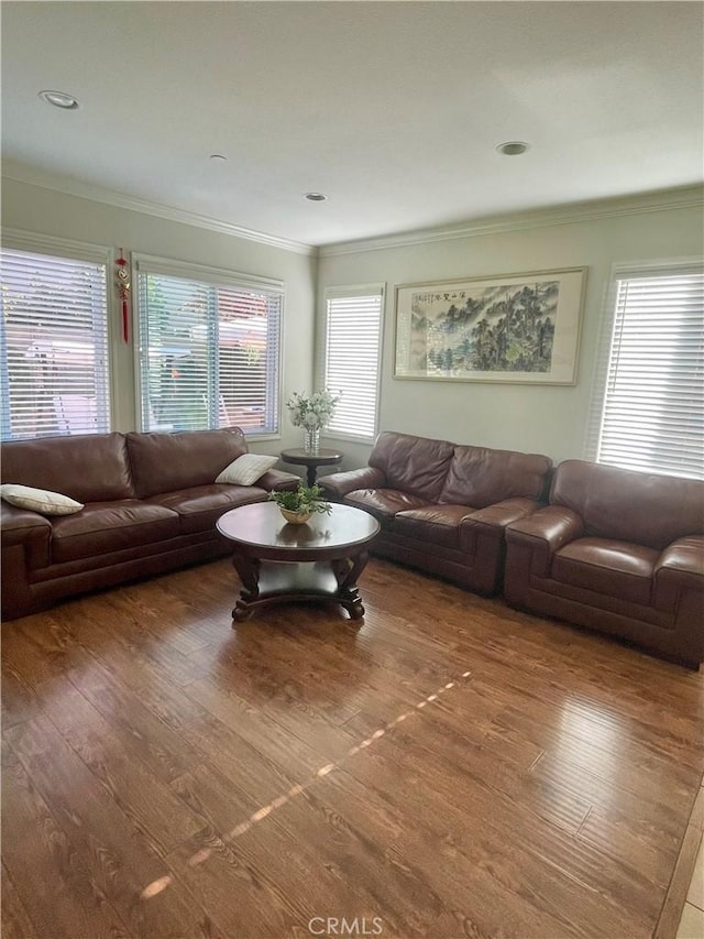 living room with crown molding and hardwood / wood-style flooring