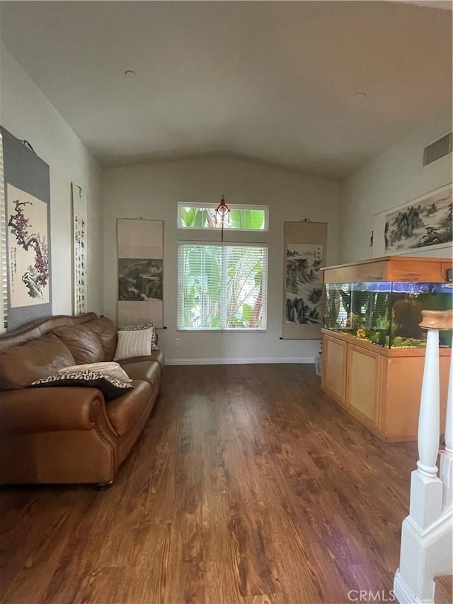 living room with vaulted ceiling and dark hardwood / wood-style floors