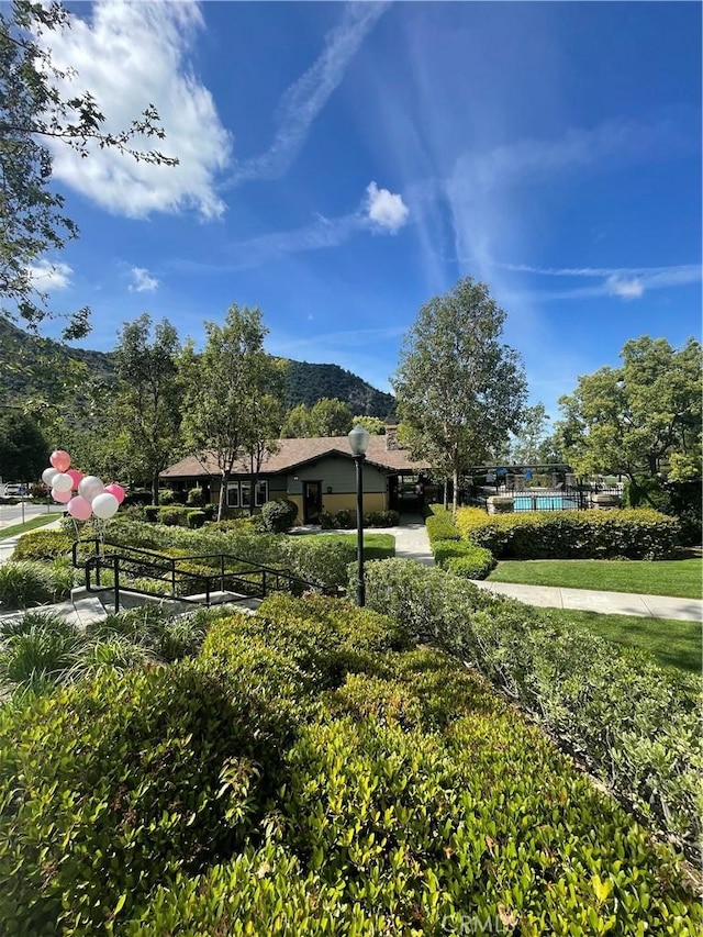 exterior space featuring a mountain view and a swimming pool