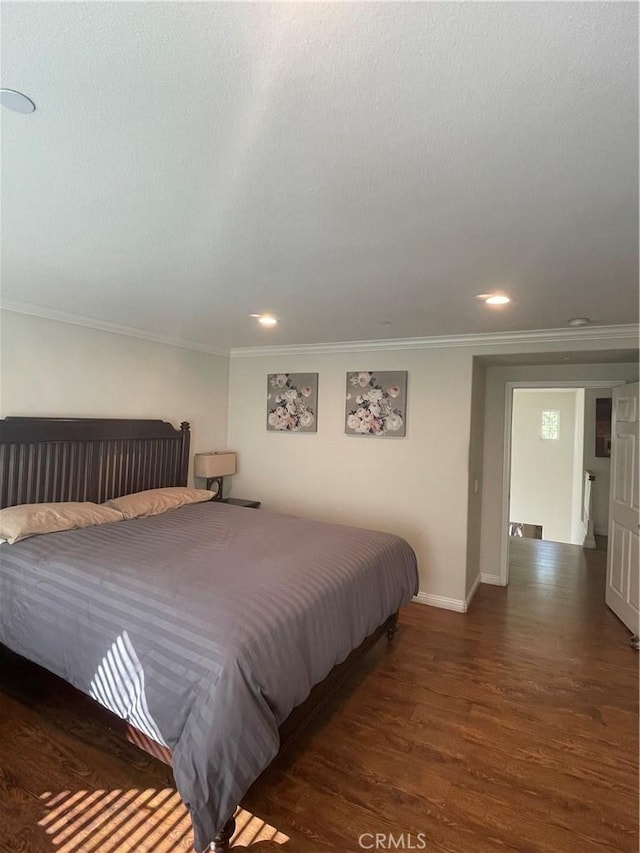 bedroom with dark wood-type flooring and crown molding