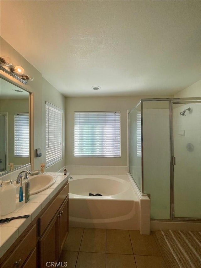 bathroom featuring a textured ceiling, tile patterned floors, vanity, and independent shower and bath