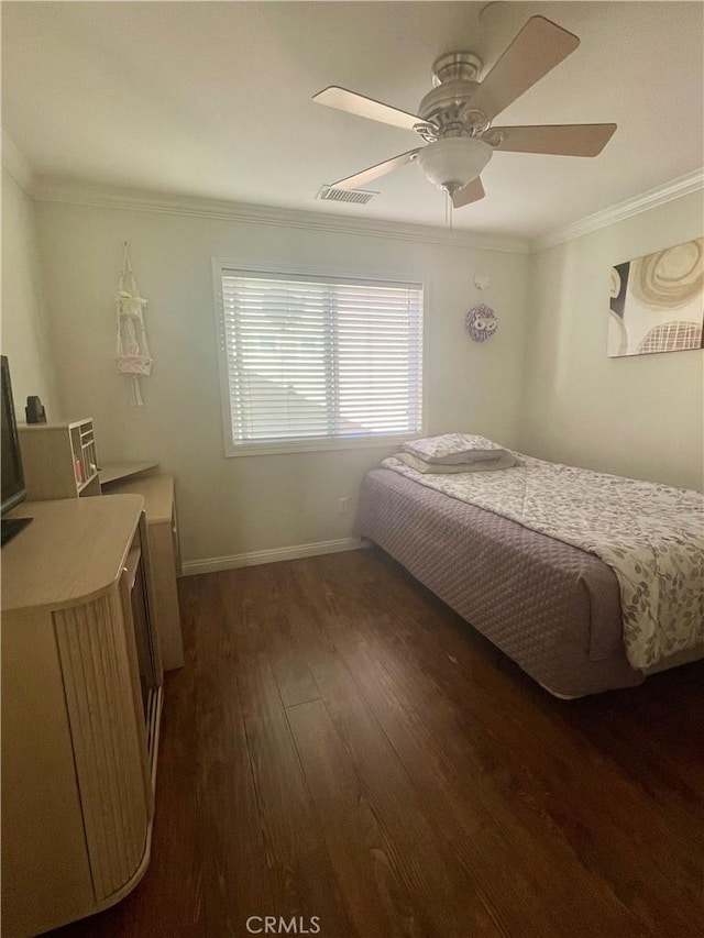 bedroom featuring dark wood-type flooring, ceiling fan, and ornamental molding