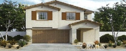 mediterranean / spanish-style home with a garage