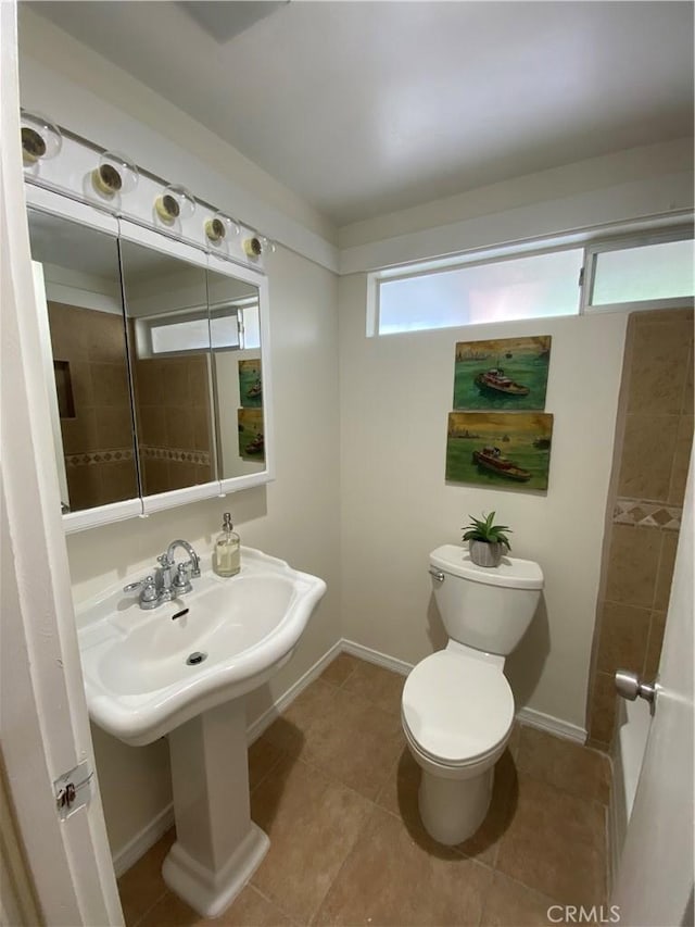 bathroom with tile patterned flooring and toilet