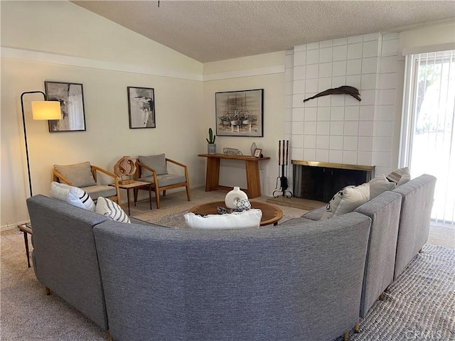 living room featuring a textured ceiling, light colored carpet, vaulted ceiling, and a tiled fireplace