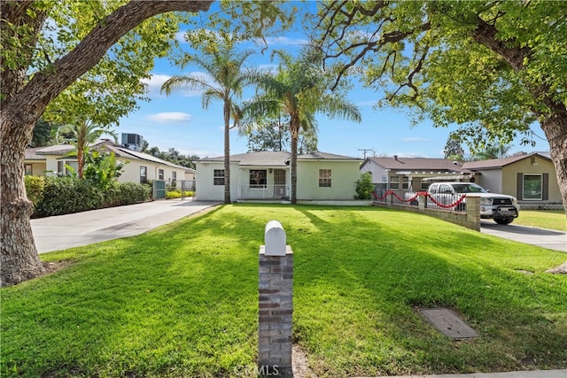 ranch-style home with a front lawn