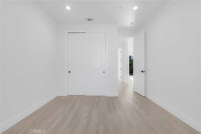 empty room with light hardwood / wood-style flooring