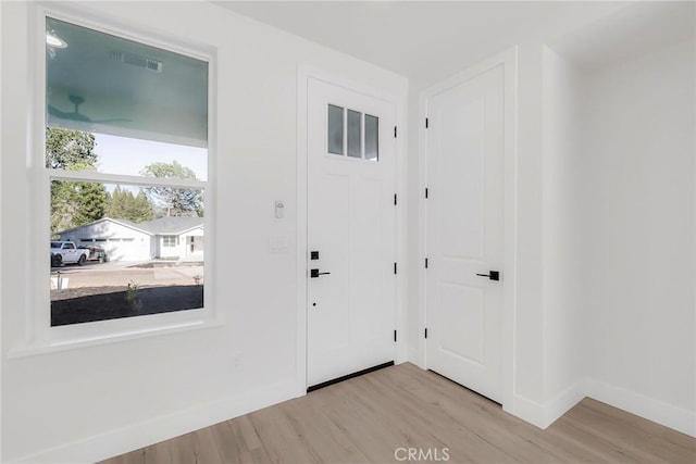 foyer entrance with light hardwood / wood-style floors