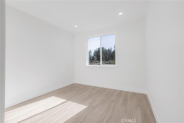 unfurnished room with light hardwood / wood-style flooring