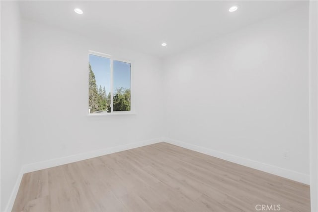 spare room with light hardwood / wood-style floors