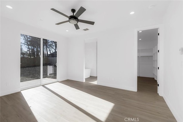 empty room with ceiling fan and dark hardwood / wood-style flooring