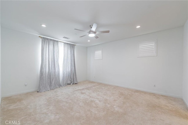 unfurnished room with ceiling fan and light colored carpet