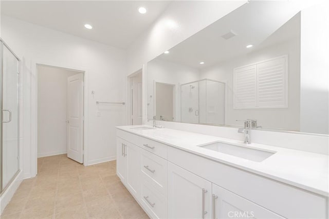 bathroom featuring tile patterned flooring, vanity, and walk in shower