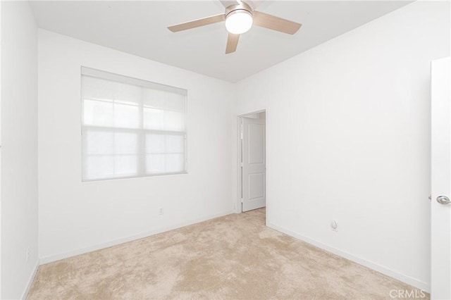 unfurnished room with ceiling fan and light colored carpet