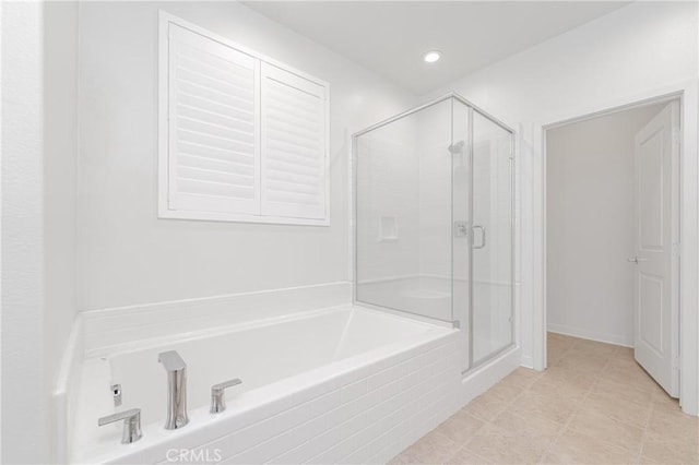 bathroom with tile patterned flooring and separate shower and tub