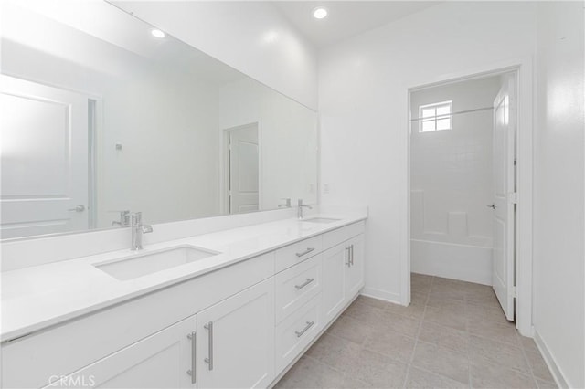 bathroom featuring a tile shower, tile patterned flooring, and vanity