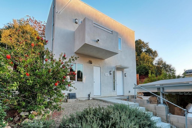 back of house featuring stucco siding