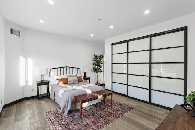 bedroom with light hardwood / wood-style floors