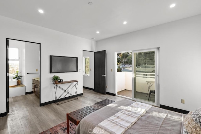 bedroom with access to exterior and light hardwood / wood-style floors