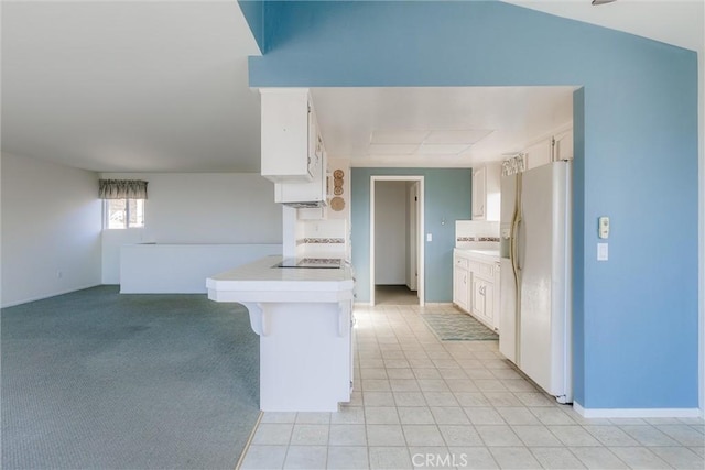 kitchen featuring white cabinetry, kitchen peninsula, black electric stovetop, a breakfast bar area, and white fridge with ice dispenser