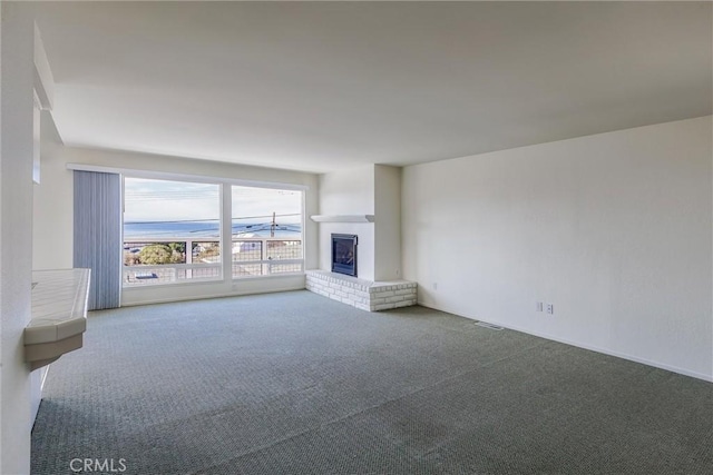 unfurnished living room featuring a fireplace and carpet floors