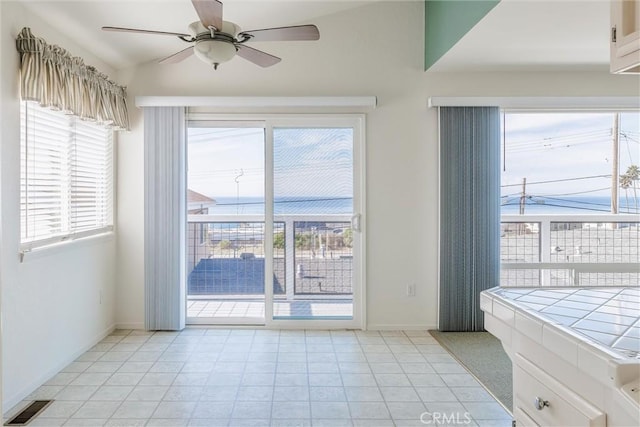 doorway with ceiling fan