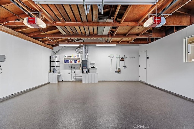 garage featuring secured water heater and a garage door opener