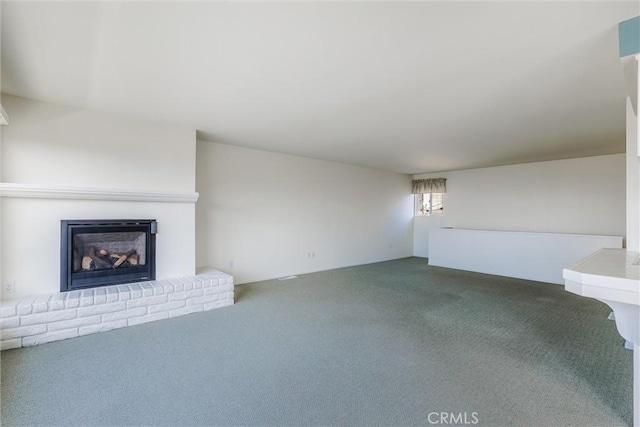 unfurnished living room with a fireplace and carpet flooring