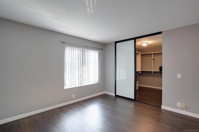 empty room with dark wood-type flooring