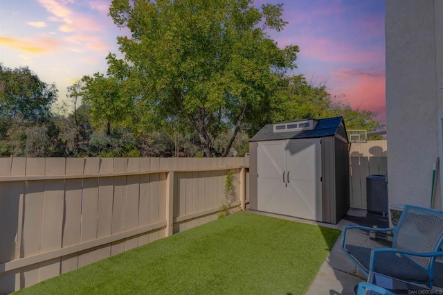 yard at dusk with a storage unit and cooling unit