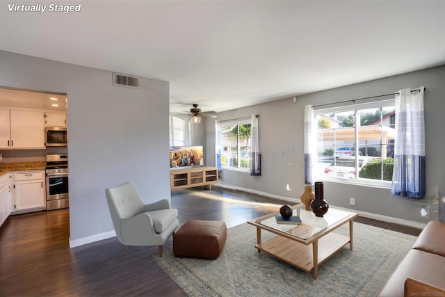 living room featuring dark hardwood / wood-style floors and ceiling fan