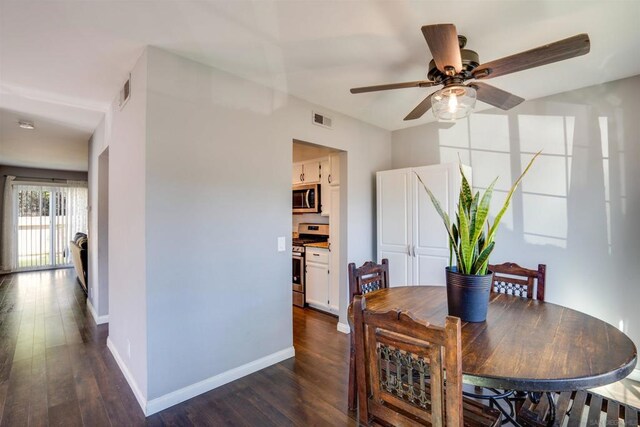 dining area featuring ceiling fan and dark hardwood / wood-style flooring