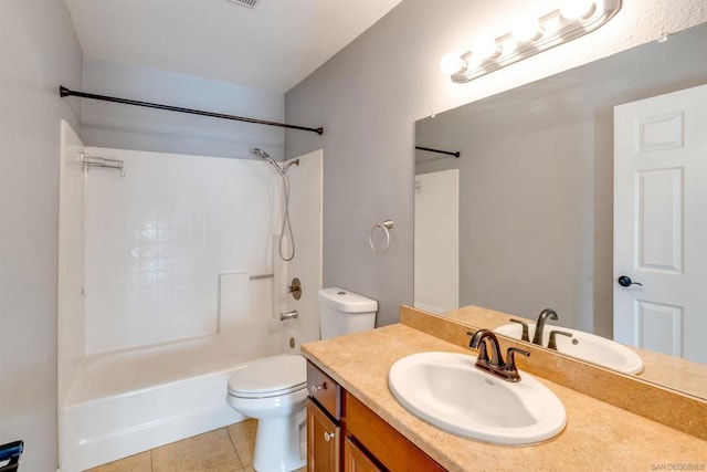 full bathroom with toilet, vanity, tile patterned floors, and washtub / shower combination