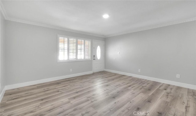 unfurnished room with light hardwood / wood-style floors and ornamental molding