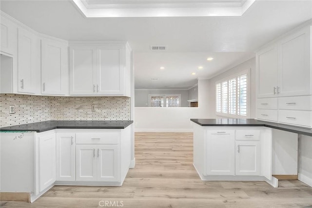 kitchen featuring crown molding and white cabinets