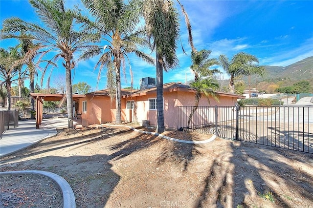 view of property exterior with a mountain view