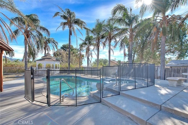 view of swimming pool featuring a jacuzzi, a gazebo, and a patio area