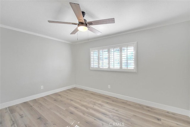 empty room featuring crown molding and light hardwood / wood-style flooring