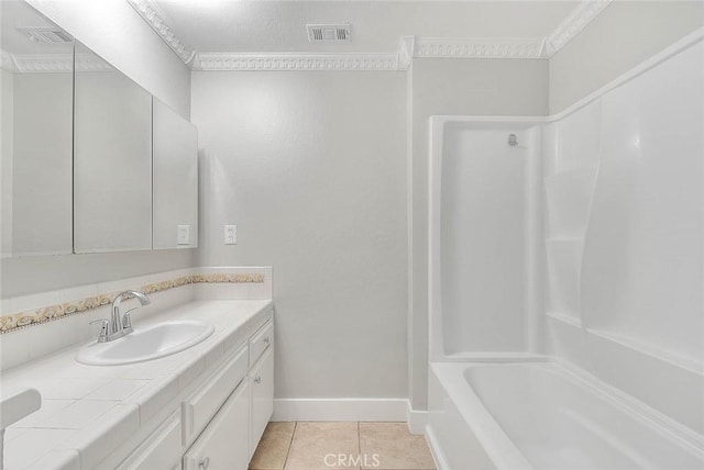 bathroom featuring crown molding, tile patterned flooring, vanity, and tub / shower combination