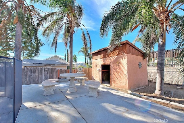 view of patio / terrace with a shed