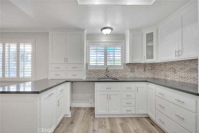 kitchen featuring sink, white cabinets, and plenty of natural light