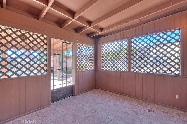 exterior space with beam ceiling, a healthy amount of sunlight, and coffered ceiling