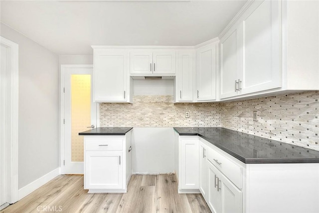 kitchen featuring white cabinets, decorative backsplash, and light hardwood / wood-style floors