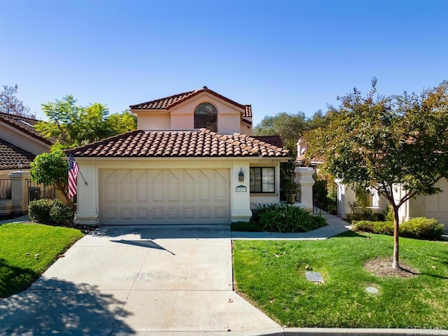 mediterranean / spanish home featuring a garage and a front yard