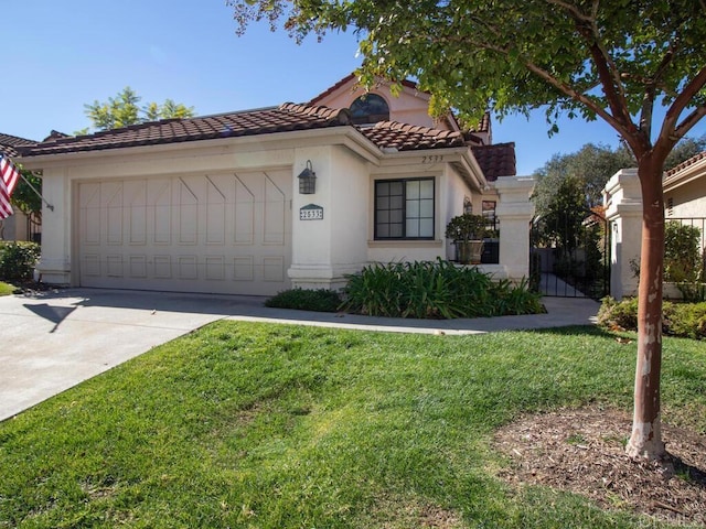 mediterranean / spanish house with a garage and a front yard